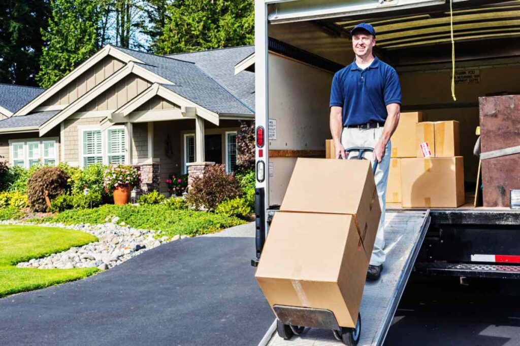 Worker carrying estate property items outdoors