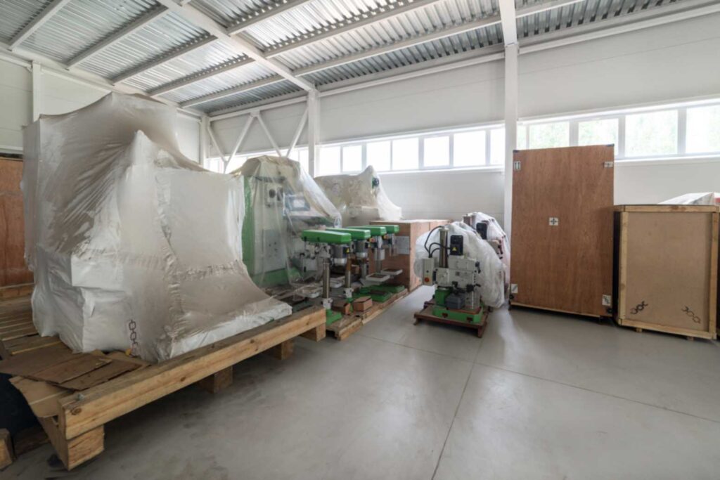 Industrial machinery securely wrapped and placed on wooden pallets for crating and shipping