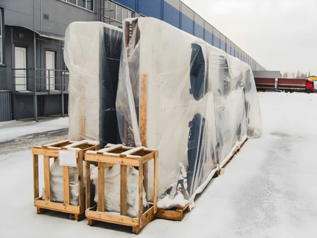 Heavy equipment wrapped for global shipping in Sacramento